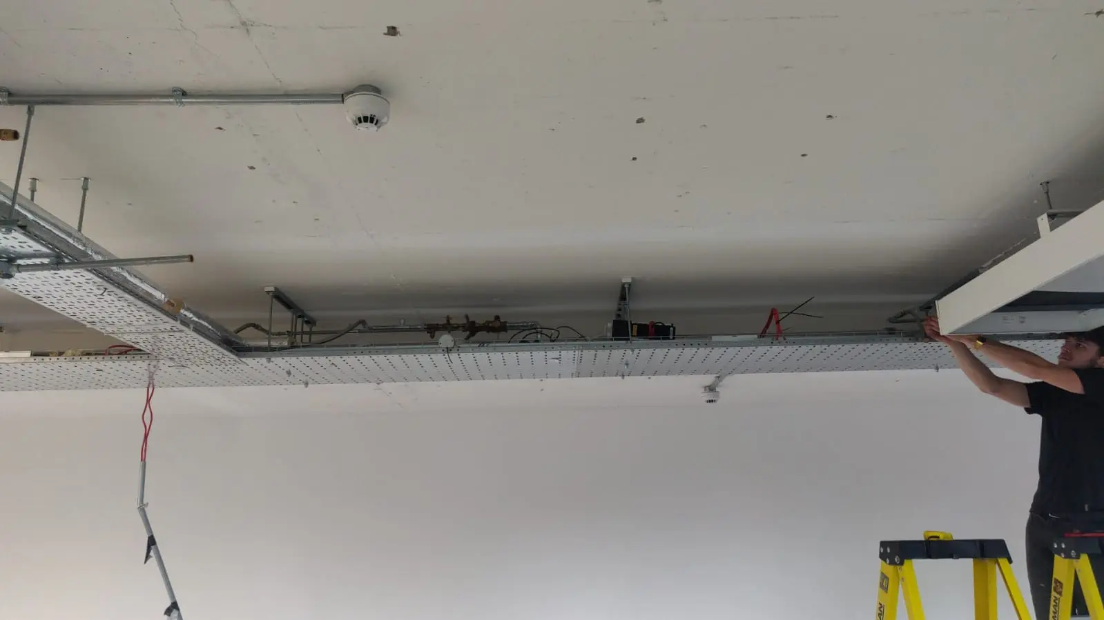 air conditioning engineer installing pipe work in London
