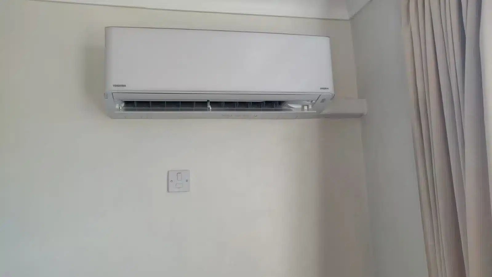 Toshiba split air conditioner unit mounted on a white wall. Installation in a domestic property in Tottenham